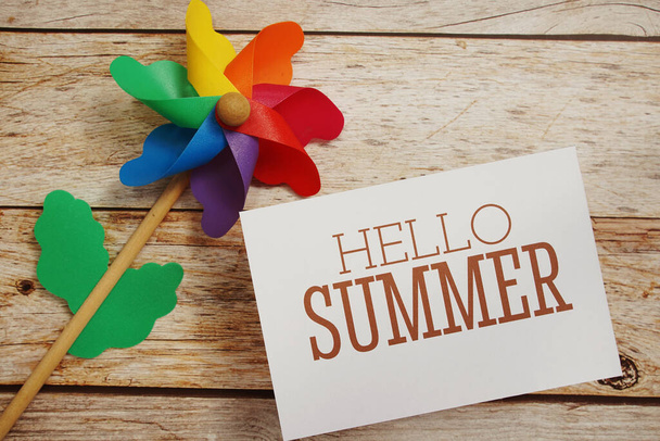 Hello Summer text message with windmill on wooden background - Photo, image