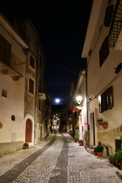 A narrow street between the old stone houses of Caramanico Terme, a medieval village in the Abruzzo region of Italy. - Fotó, kép