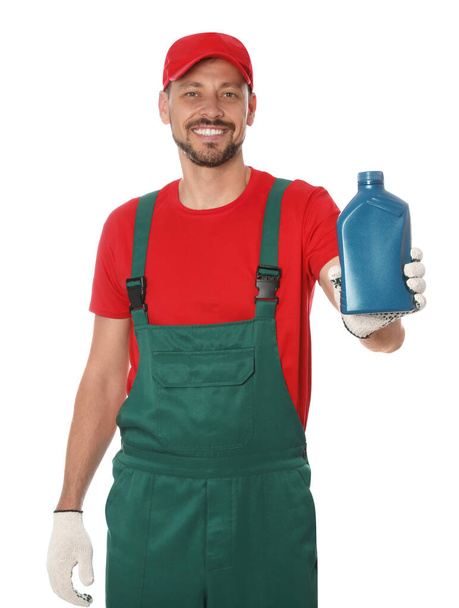 Man holding blue container of motor oil on white background - Foto, Imagem