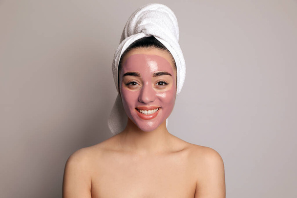 Woman with pomegranate face mask on grey background - Photo, image