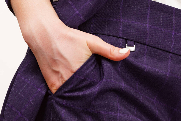 Business woman wearing suit holding hand in pants pocket. Detail view hips in trousers - Фото, изображение
