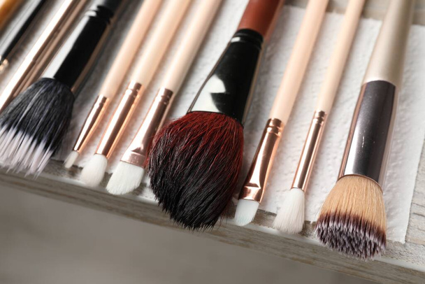 Set of different makeup brushes drying after cleaning on table, closeup - Fotó, kép