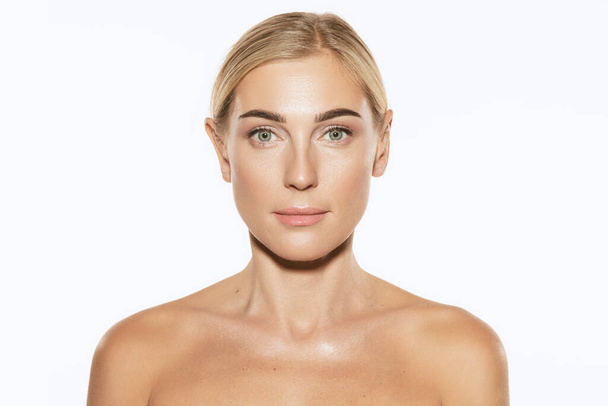 Looking at camera. Young, beautiful 35 years old woman, blonde with well-kept skin isolated on white background. Spa, anti-aging treatment, face lifting and skin care concept - Φωτογραφία, εικόνα