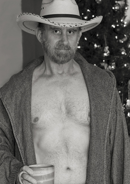 Un Cowboy in abito aperto vicino a un albero di Natale
 - Foto, immagini