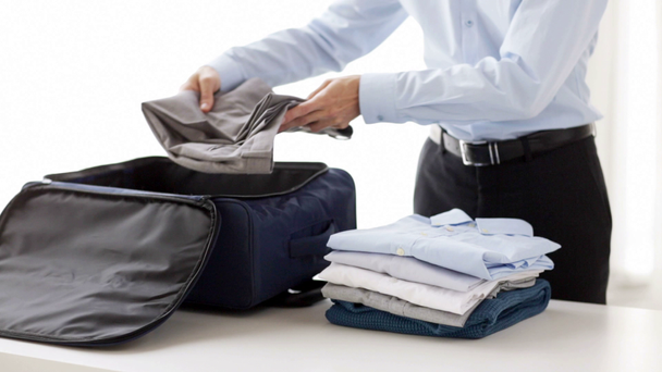 businessman packing clothes into travel bag - Footage, Video