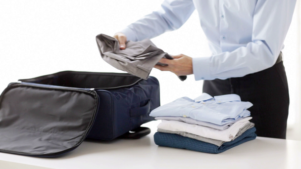 businessman packing clothes into travel bag - Footage, Video