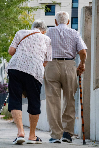 Elderly couple walking together in the street with happy lifestyle, and romantic. Always together and ever concept - Photo, Image