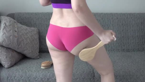 problem of orange peel skin, woman with cellulite is doing anti-cellulite massage on legs back part, buttocks with brush at home, get rid of fat, skin care, body perfection  - Footage, Video
