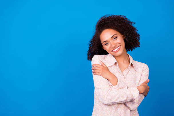 Portrait of lovely gorgeous lady toothy smile hands hug shoulders empty space isolated on blue color background. - Foto, Imagem