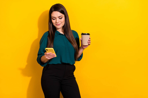 Photo of adorable cute lady dressed green shirt reading gadget drinking tea empty space isolated yellow color background. - Φωτογραφία, εικόνα
