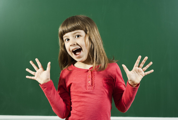 Girl is having fun in front of blackboard - Фото, зображення