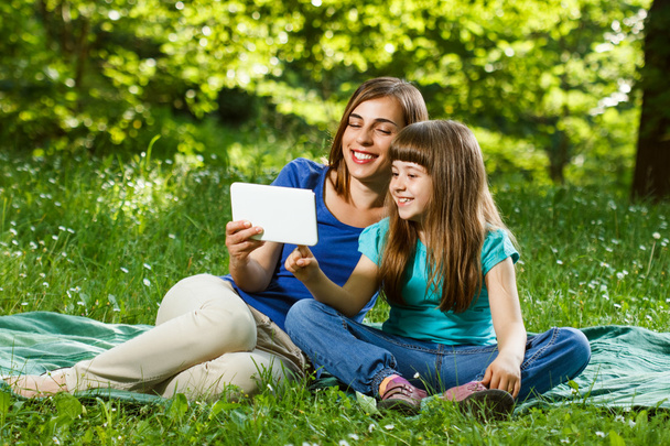 Mother and daughter using digital tablet - 写真・画像