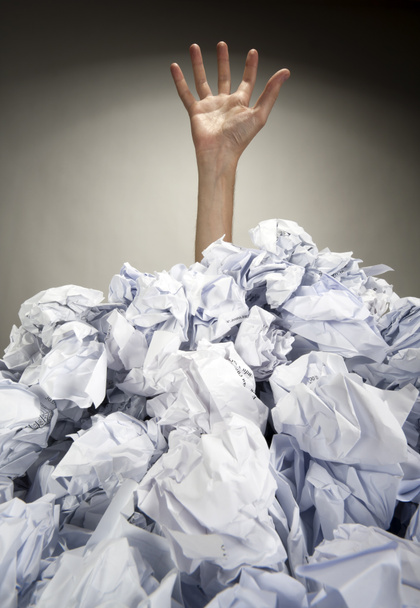 Hand reaches out from heap of papers - Photo, Image
