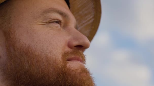 Side view of young man in hat thinking with serious face and looking at the sky. Close up of face of male farmer considering something. Indoors. Portrait. High quality 4k footage - Footage, Video