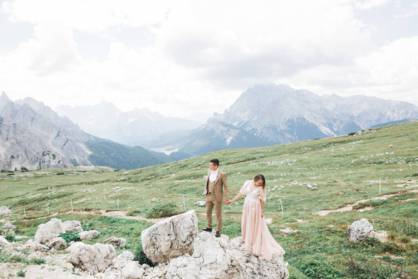 Beautiful gorgeous bride posing to groom and having fun near at mountains with amazing view, space for text, wedding couple. - Fotografie, Obrázek