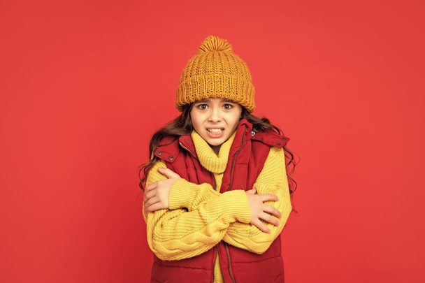 female fashion model. teen girl in down vest. portrait of child wearing warm clothes. express emotion. winter fashion. kid with curly hair in hat feel cold. - Zdjęcie, obraz
