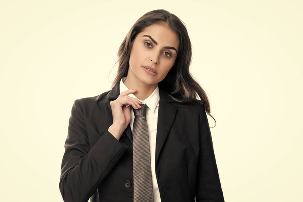 Business woman in suit and tie. Confident female entrepreneur. Businesswoman correct necktie, prepare for business meeting. Portrait of attractive elegant fixing suit isolated on white background - Zdjęcie, obraz