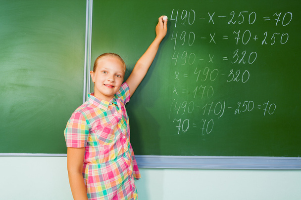 Girl writing mathematics equation - Photo, Image
