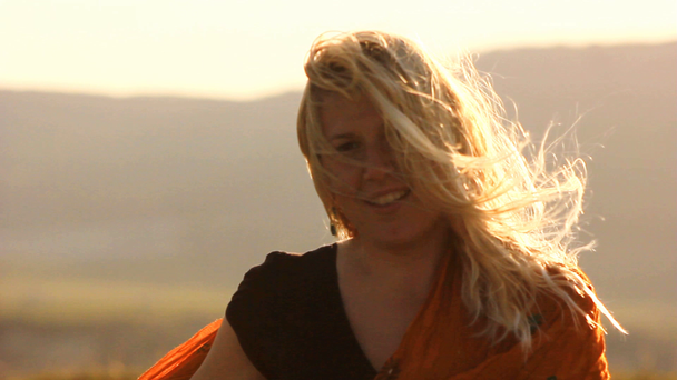 blond meisje op de winderige heuvel - Video
