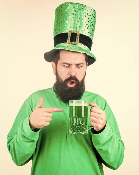 Alcohol consumption integral part saint patricks day. Irish tradition. Man brutal bearded hipster drink pint beer. Irish pub. Green beer mug. Drinking beer part celebration. Bar seasonal holiday menu. - 写真・画像