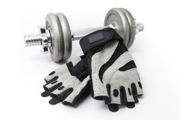Dumbbell and Fitness Gloves on white background - Foto, Bild