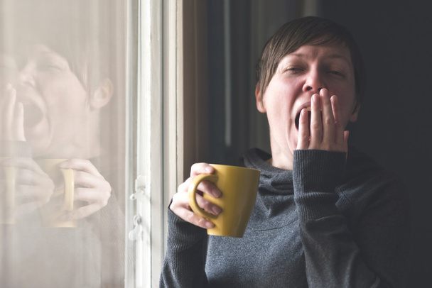 Beautiful Woman Drinking Coffee and Yawning - Valokuva, kuva