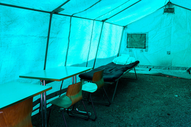 View inside the medical tent of a field hospital for emergencies. Background with selective focus and copy space for text - Foto, Bild