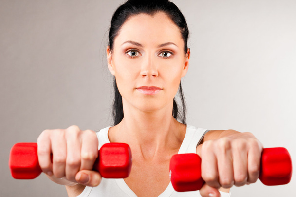 Woman is holding barbells - Photo, Image