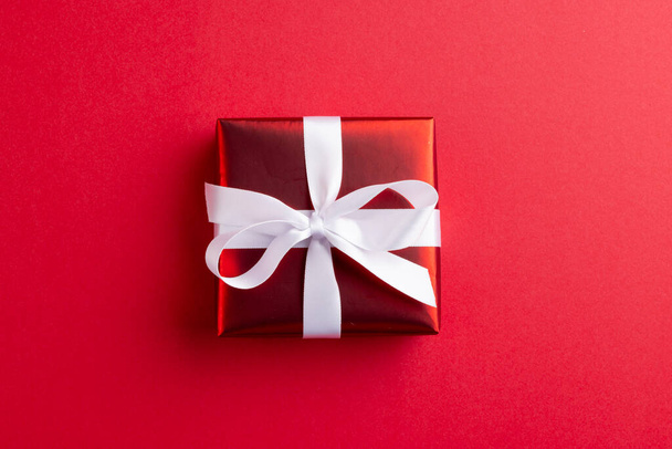 Image of red christmas gift decoration and copy space on red background. Christmas, tradition and celebration concept. - Φωτογραφία, εικόνα
