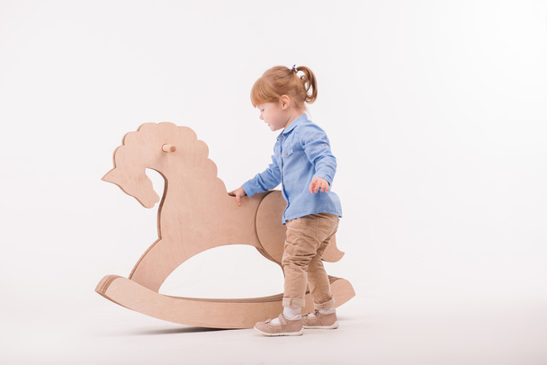 Child with the toy horse - Fotó, kép