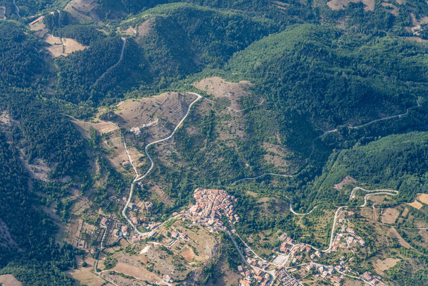 aerial shot, from a small plane, of Cabbia hilltop village, shot in bright summer light from south, Apennines, L'Aquila, Abruzzo,  Italy - Photo, Image