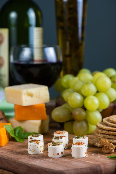 selection of soft cheese with fruits, spices and meat on board - Photo, Image