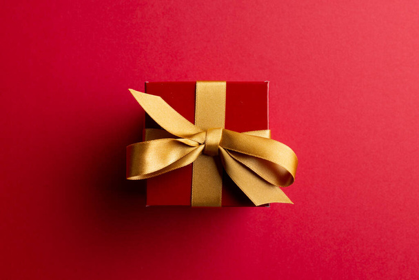 Image of red christmas gift decoration and copy space on red background. Christmas, tradition and celebration concept. - 写真・画像