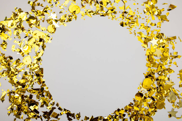 Composition of close up of new years confetti on white background. New year's eve party, celebration and copy space concept. - Фото, изображение