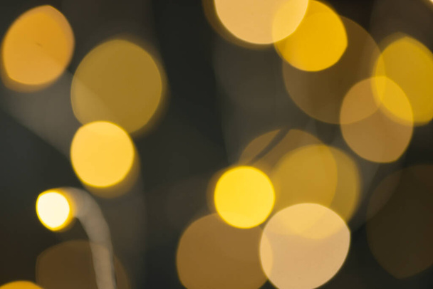 Image of yellow christmas out of focus fairy lights background. Christmas, tradition and celebration concept. - 写真・画像