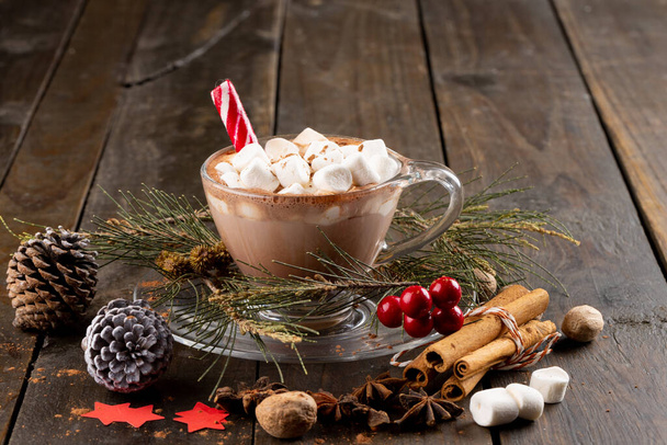 Image of cup with christmas hot chocolate and marshmallows on wooden background. Christmas, tradition and celebration concept. - Photo, Image