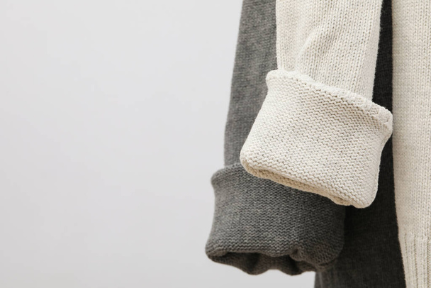 Hanging sweaters, concept of autumn season clothes - 写真・画像