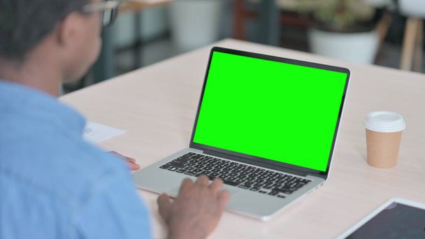 African Man Using Laptop with Green Screen - 写真・画像