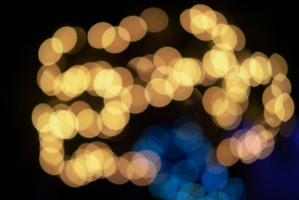 Verschwommenes Licht und Bokeh-Licht von defokussierter Urlaubsbeleuchtung. Weihnachtlicher Hintergrund. - Foto, Bild