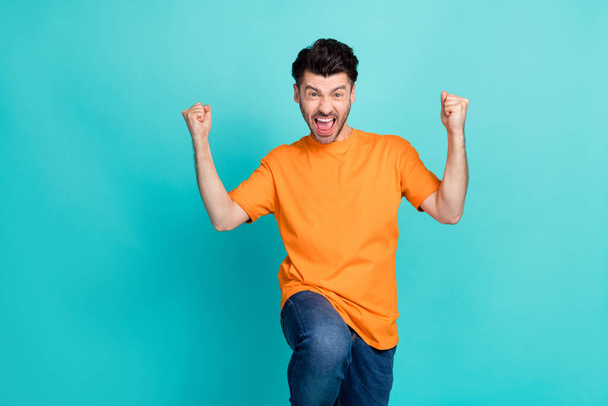 Photo of young attractive handsome funny positive guy celebrate fists up winner enjoy driving test done crazy isolated on aquamarine color background. - Fotoğraf, Görsel