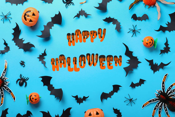 Frame made with Halloween decor elements on light blue background, flat lay - Foto, imagen