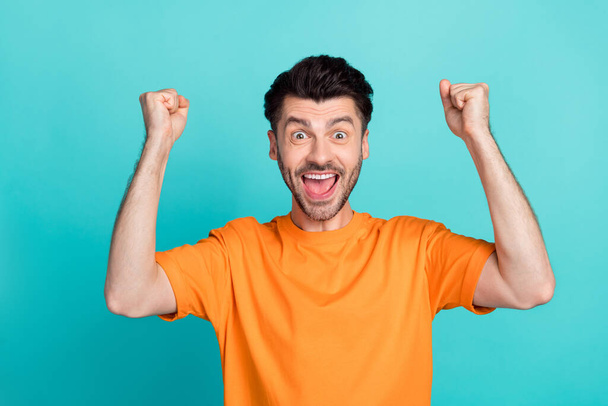 Closeup photo of young attractive handsome funny man excited fists up celebrate hooray winner tournament positive nice isolated on aquamarine color background. - Foto, Bild