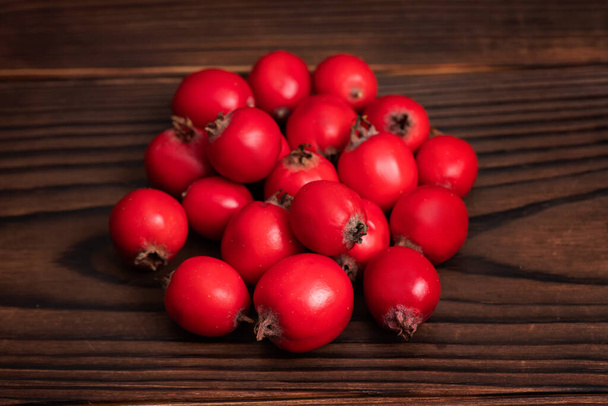 pile hawthorn fruits on wooden backgrounds. close up. - Photo, Image