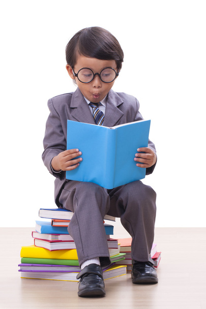Cute boy in suit reading a book - Photo, image