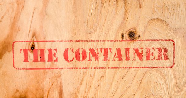 Stamp THE CONTAINER on wood background - Photo, Image