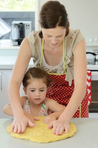 Mother and child kneading dough - Photo, image