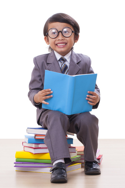 Cute boy in suit reading a book - Фото, изображение