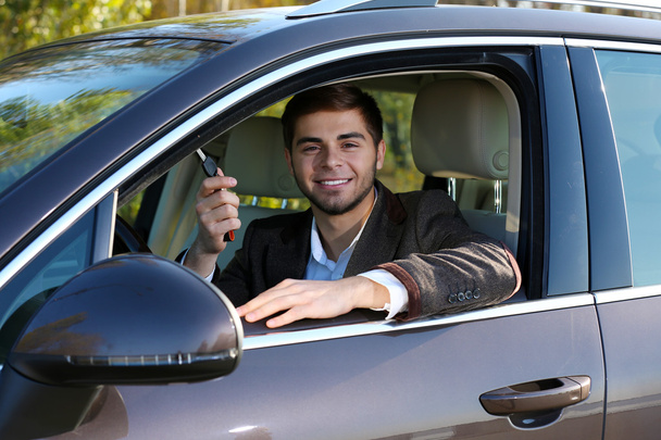 Man with car key in car - Foto, Imagen