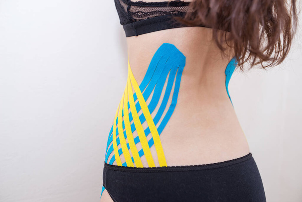 kinesio tape on the sides of the abdomen of a young girl. - Valokuva, kuva