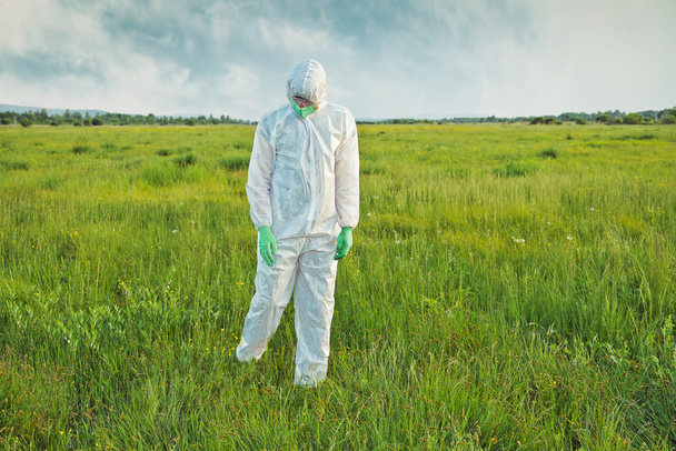 Scientist in uniform analyzing grass - Фото, изображение